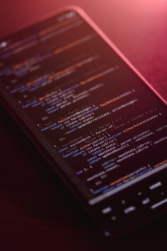 About Colorful code displayed on a smartphone screen with a warm glow.